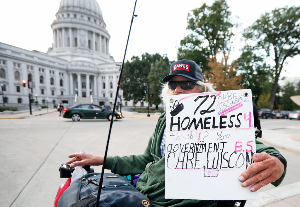 homeless person in front of Wisconsin State Capitol