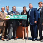 Michael Aubinger, who also served as the Ashwaubenon village president, right, at the unveiling of the Mike McCarthy Way street sign prototype in 2014. With Aubinger, from left, were, Green Bay Mayor Jim Schmitt and Green Bay Packers Coach Mike McCarthy. Aubinger played an instrumental role in the village's economic growth and development, notably the Green Bay Packaging expansion and the early stages of the Titletown District development surrounding Lambeau Field.