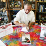 ____Larry signing 1st edition of novel